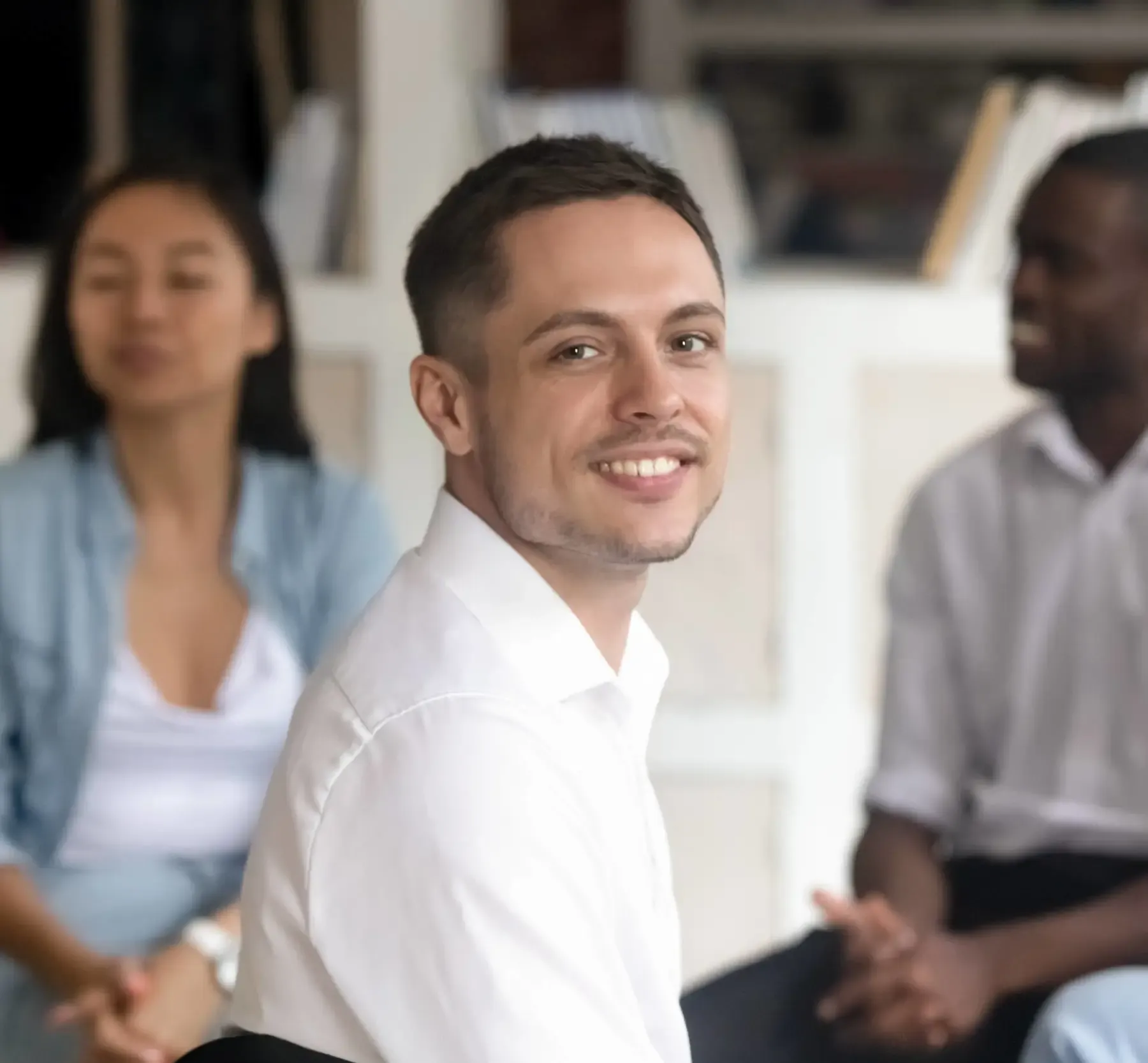 Man Facing Camera During Group Therapy Session